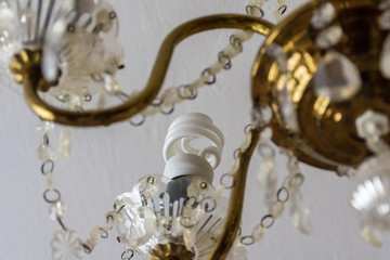 Energy saving lamp in an old vintage chandelier