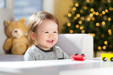 Happy toddler boy playing on Christmas Day