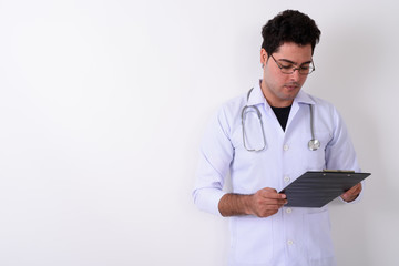 Young handsome Persian man doctor wearing eyeglasses against whi