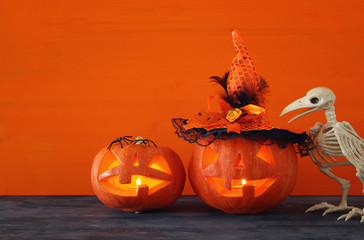 Halloween holiday concept. Pumpkins over wooden table.