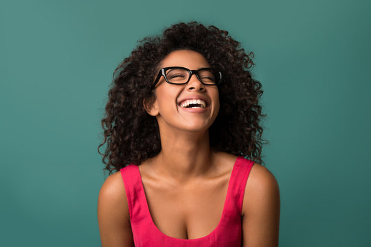 Happy African-american Woman Laughing Over Blue Background