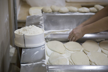Fototapeta na wymiar Manufacturer of pita bread