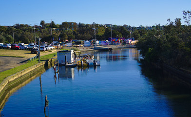 View of blue river with boat hire dock