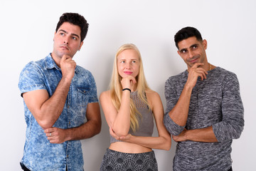 Three multi-ethnic friends together against white background
