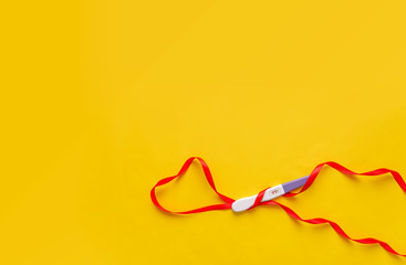 Pregnancy test on a yellow background. The result is positive. Two strips.