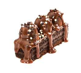 Chocolate cake with truffles poured with milk chocolate syrup