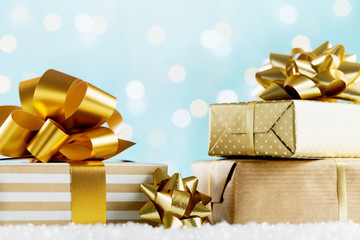 Heap of golden gifts or presents boxes on magic bokeh background. Holiday composition for Christmas or New Year.