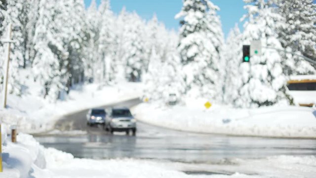 Snowy traffic intersection with slow cars and icy roads background plate