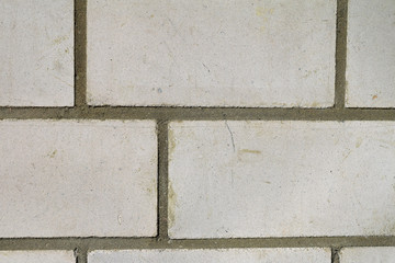Old dirty white brick wall close up