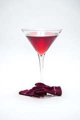 Huge glass with red wine on white background