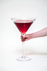 Female hand holding huge glass of wine