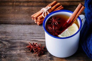 Autumn hot tea with spices cinnamon and anise in mug