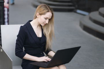 Young businesswoman working at laptop. Selective focus.