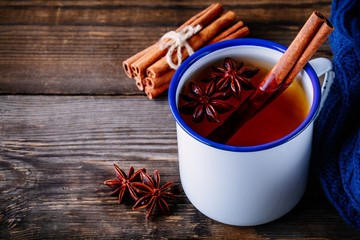 Autumn hot tea with spices cinnamon and anise in mug