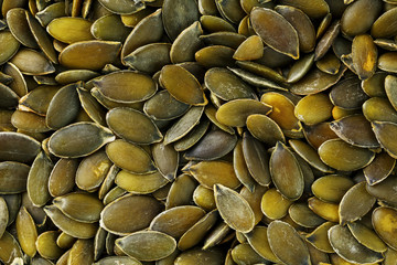 Macro background texture of green pumpkin seeds