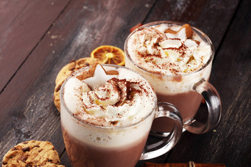 Hot chocolate cocoa with whipped cream on table.