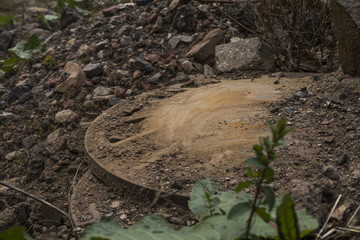 Old sewer cover with dirt