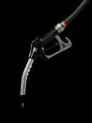 GAS PUMP WITH SINGLE DROP OF FUEL ON BLACK BACKGROUND