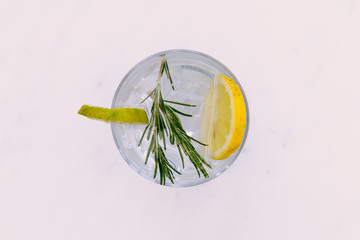 Gin tonic cocktail drink with green lime top view white background