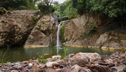 Fototapeta premium Budlaan waterfalls outdoor activities hiking along a river creek watercourse passing bamboo bridge, series of images in Cebu province