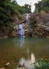 Fototapeta na wymiar Budlaan waterfalls outdoor activities hiking along a river creek watercourse passing bamboo bridge, series of images in Cebu province