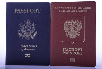 Naklejka premium Passport of USA next to Passport of Russia on white background. Double international citizenship concept.