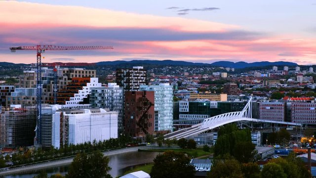 Oslo, Norway. A sunrise view of Sentrum area of Oslo, Norway, with Barcode buildings and the river Akerselva. Construction site with morning colorful sky