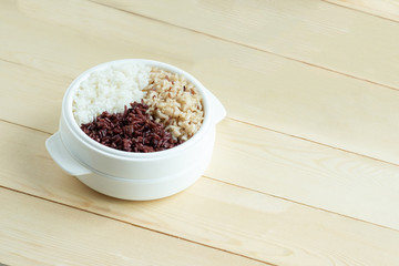 Mix of cooked rice in plastic bowl