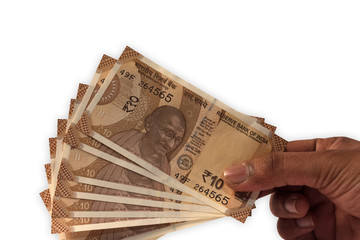 Holding new Indian 10 Rupee currency notes in hand.