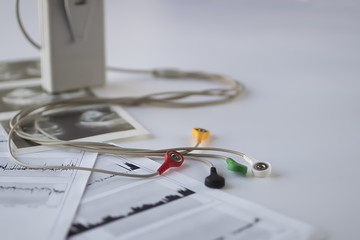 Device of holter monitoring and pills on white background. Concept of diagnosis and treatment of cardiovascular diseases.