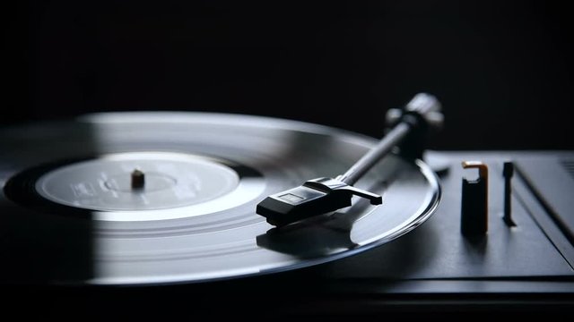 Music playing on retro vinyl gramophone.