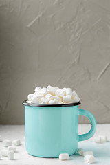 Mug of cocoa with marshmallows on the table