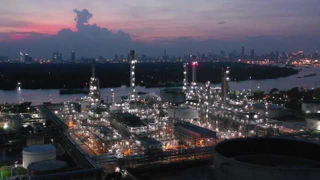 Video Industrial view at oil refinery plant form industry zone with sunrise and cloudy sky.Oil refinery and Petrochemical plant at dusk,Thailand. Aerial view