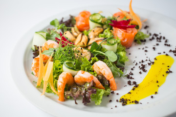 Seafood fresh salad with shrimps, mussels, salmon, green and cucumber