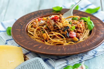Spaghetti with bolognese sauce, vegetables and basil.