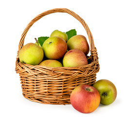 Ripe apples in a basket close-up on a white. Isolated