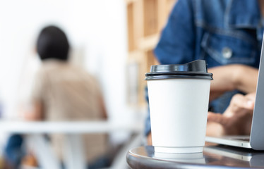 Women are using laptop and drinking hot coffee.