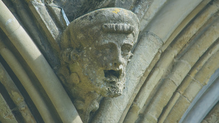 Corbel Head on The West Front of Salisbury Cathedral A, Gargoyle on Early English Gothic Cathedral, shallow depth of field split toning horizontal photography © Jacek Wojnarowski