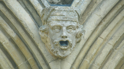 Corbel Head on The West Front of Salisbury Cathedral K, Gargoyle on Early English Gothic Cathedral, shallow depth of field split toning horizontal photography © Jacek Wojnarowski