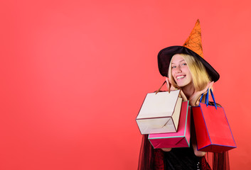Halloween shopping. Happy woman in witch halloween costume with shopping bags. Colorful Halloween....