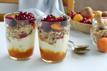 Dessert with cream, jam, muesli and fresh berries in a glass © Nataliia