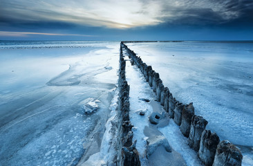 old breakwater frozen in winter