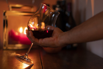 Calice di vino con  candele sullo sfondo 