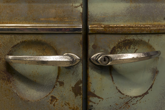 rusty doors with handles of an old retro car
