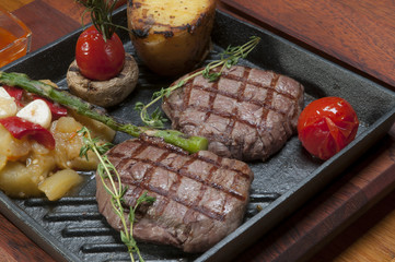 grilled meat in a cast iron pan