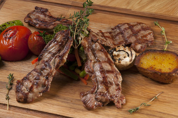 grilled lamb chops on wooden serving board