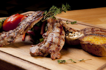 grilled lamb chops on wooden serving board