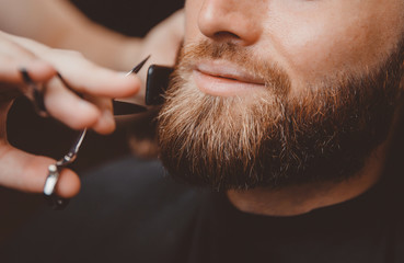 Barber process shaving razor bearded hipster man in barbershop.
