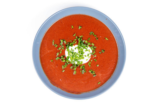 Beetroot cream soup decorated with yogurt mixed and chives