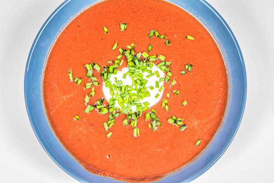 Beetroot cream soup decorated with yogurt mixed and chives